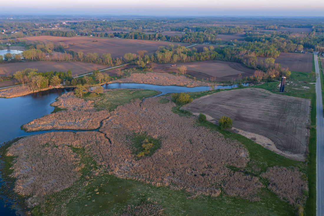Aerial view of Kayes Creek at sunset flowing toward Little Sturgeon Bay
