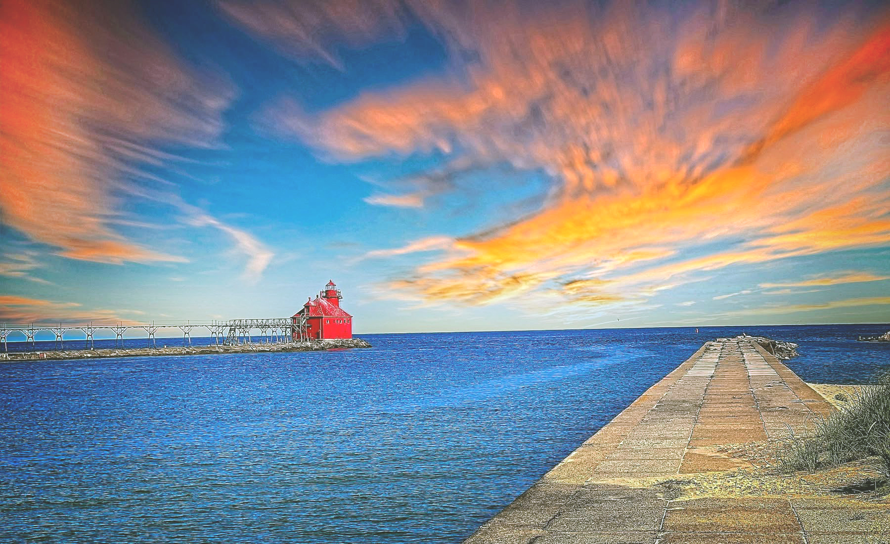 Sturgeon Bay Canal lighthouse silhouetted against a vivid sunset sky